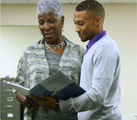 Man and Woman reading a large folder together