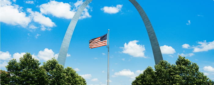 American Flag between two trees and an arc